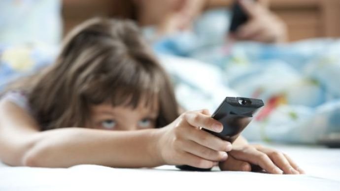 Little girl with TV remote control